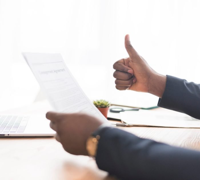 businessman-with-paper-gesturing-thumb-up